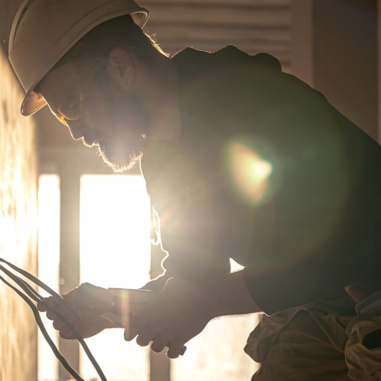 worker-is-cutting-wires-with-lineman-s-pliers worker-is-cutting-wires-with-lineman-s-pliers